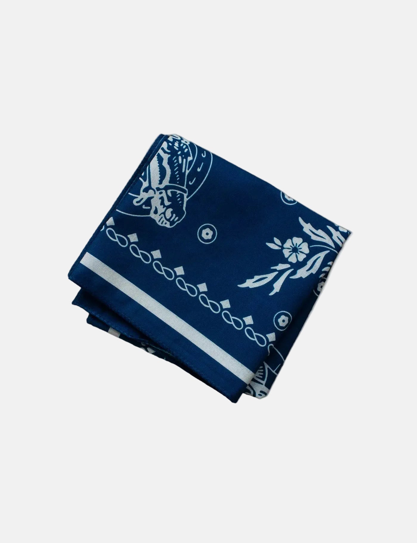 Folded navy blue bandana with white patterns on a white background